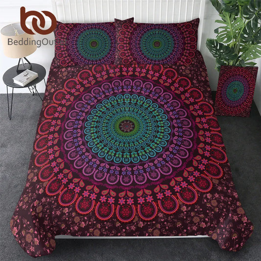 Mandala patterned bedding set on a bed with a plant and side table in the background.