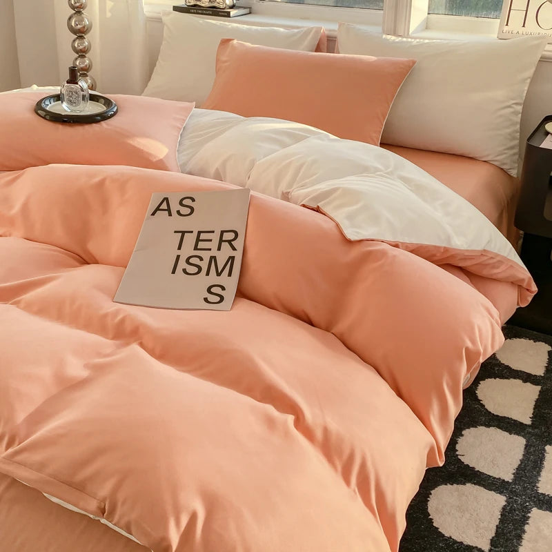 Pink bedding set with a book titled 'AS TERISMS' on a bed.