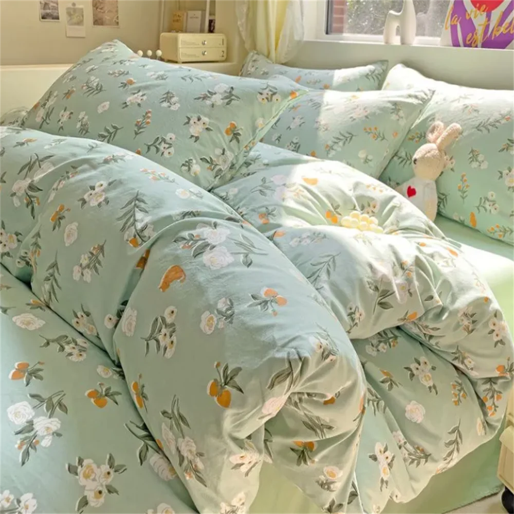 Floral patterned bedding set on a bed with a stuffed rabbit toy.