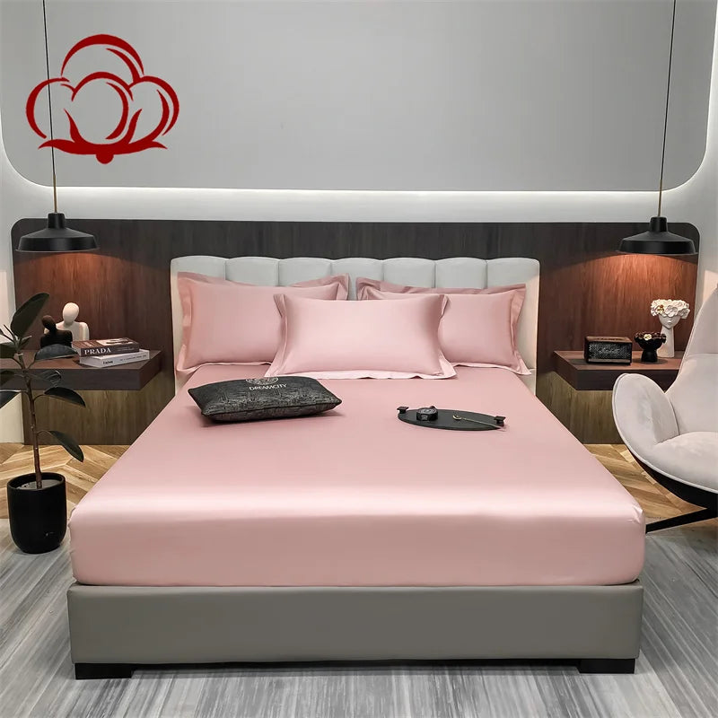 Bedroom with a bed featuring pink bedding and gray frame, nightstands with decor items, and a modern headboard.