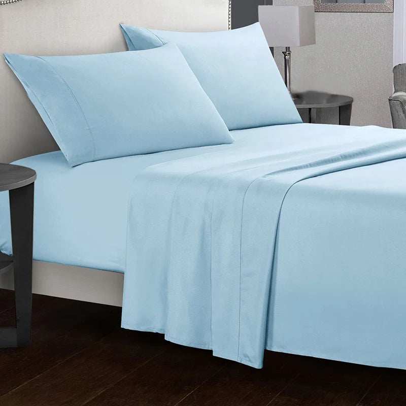 Light blue bed sheets and pillows on a bed in a bedroom setting.