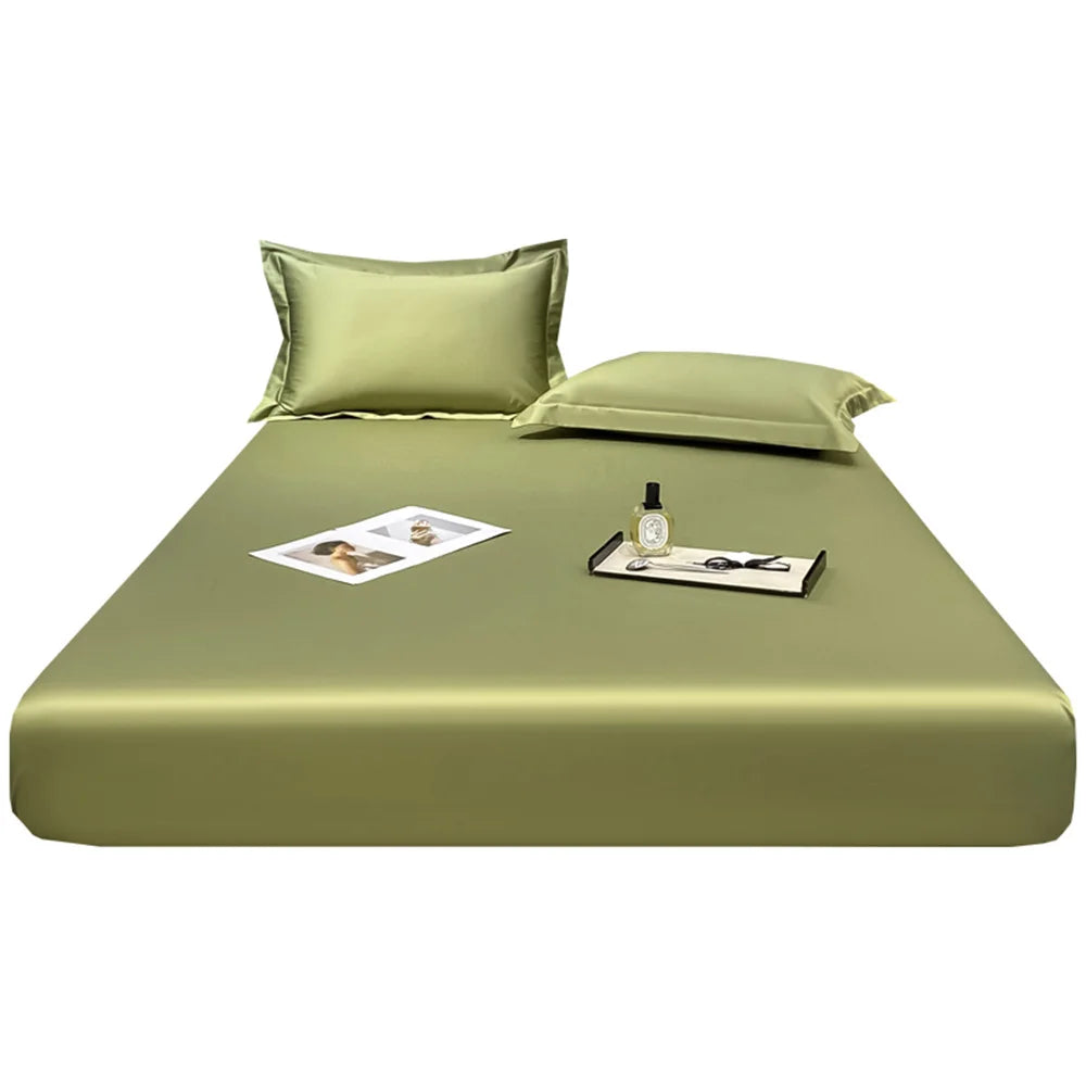 Green satin sheet set with pillowcases on a white background