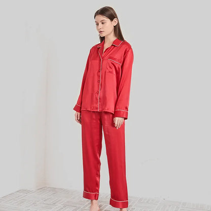 Person wearing a red satin pajama set on a plain background