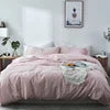 Bedding set with pink and white pattern on a bed