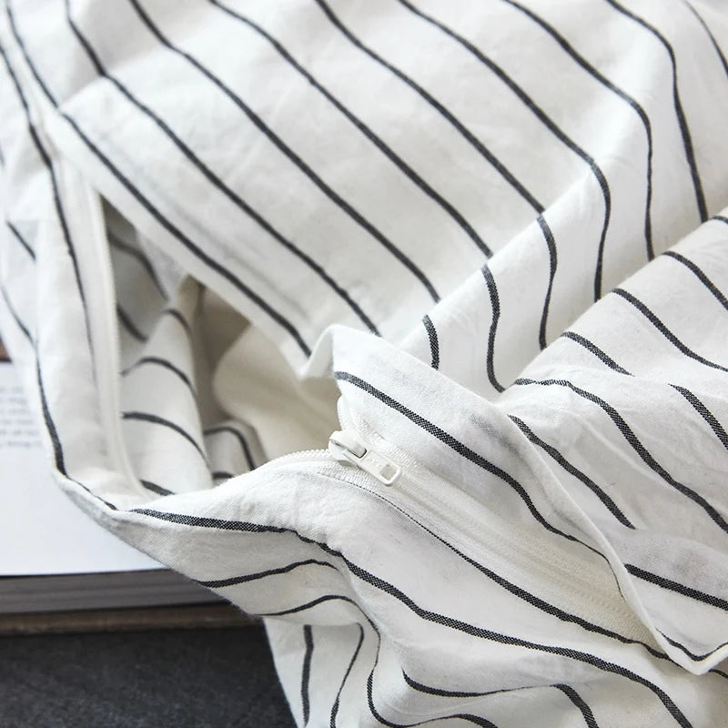 Close-up of a white fabric with black stripes on a surface.