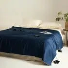Navy blue comforter on a bed in a bedroom setting