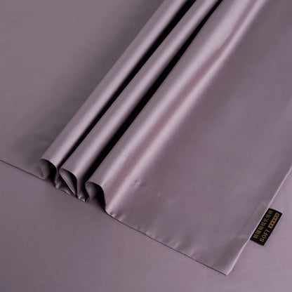 Folded gray satin fabric with a brand label on a gray background