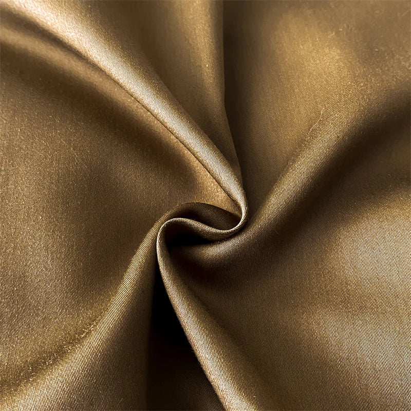 Close-up of brown satin fabric with folds