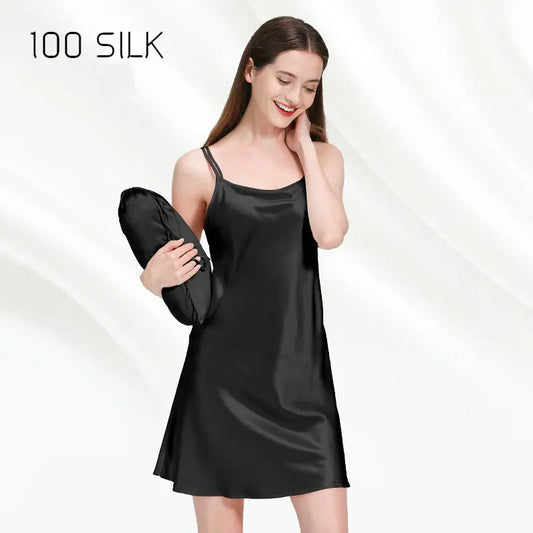 Woman wearing a black silk slip dress holding a matching bag on a white background with '100 SILK' text.