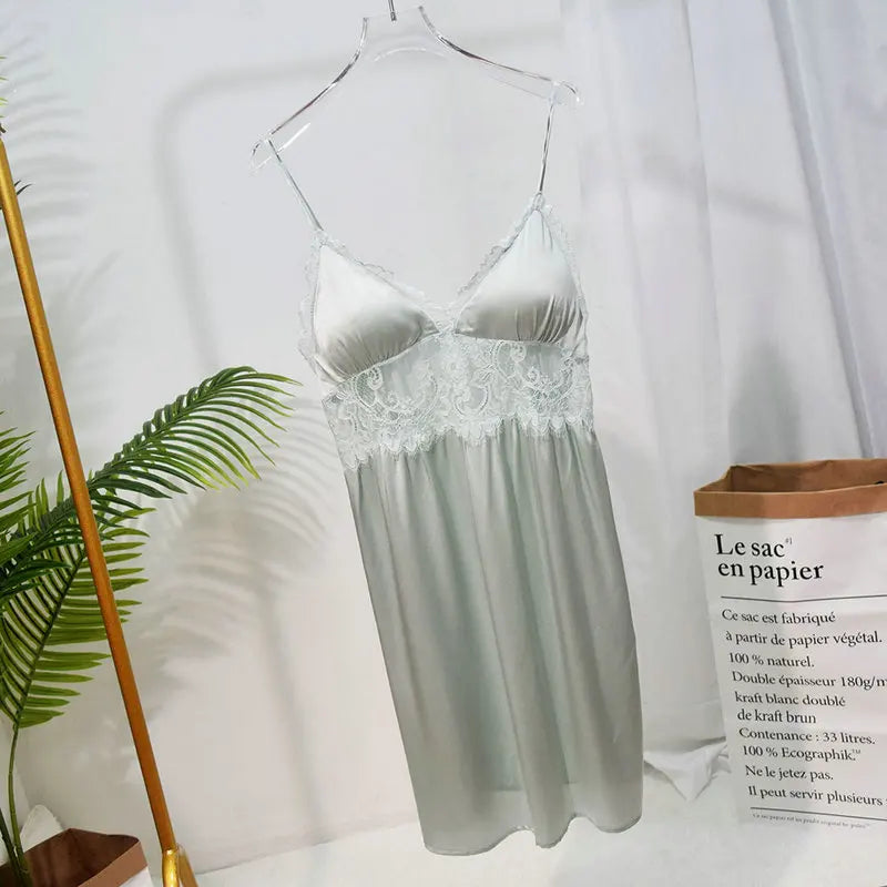 Silver nightgown with lace details on a hanger against a white background.
