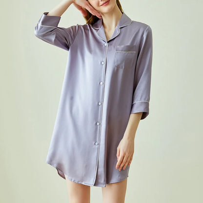 Person wearing a light purple satin nightshirt against a plain background
