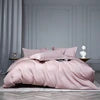 Pink bedding set on a bed with a neutral background