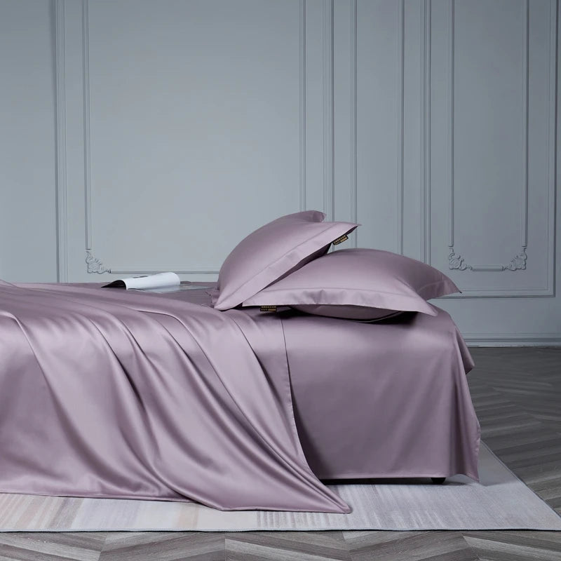 Purple satin bedding set on a bed with a neutral background