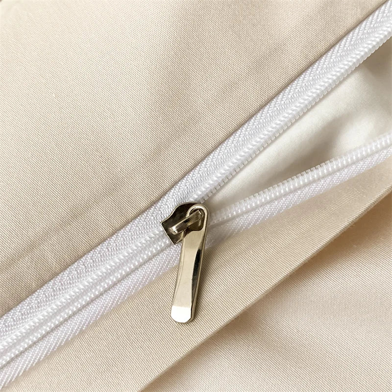 Close-up of a white zipper on beige fabric
