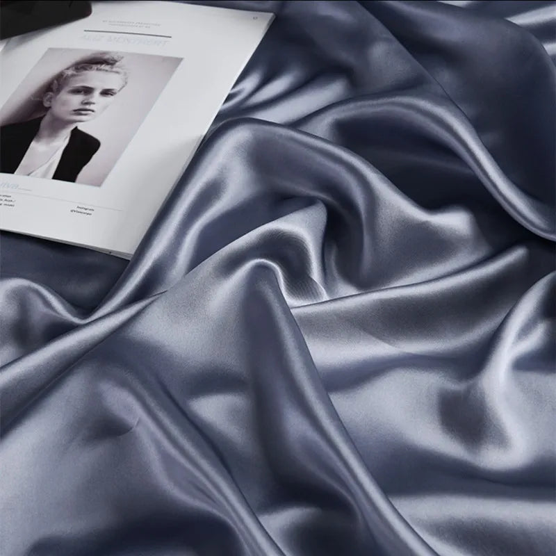 Blue satin fabric with an open book featuring a portrait on top