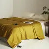 Bed with yellow bedding in a bedroom setting