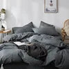 Gray bedding set on a bed with a blurred background