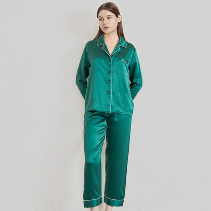 Woman wearing a green satin pajama set against a plain background