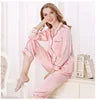 Woman wearing a pink satin robe on a white background