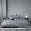 Gray bedding set on a bed with a neutral background