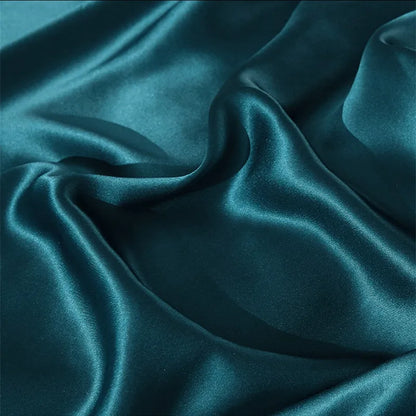 Teal satin fabric with folds