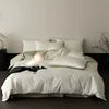 White bedding on a bed with a minimalistic background