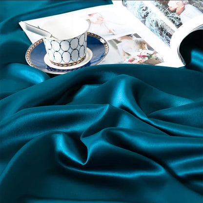Teal satin fabric with a cup and saucer on top