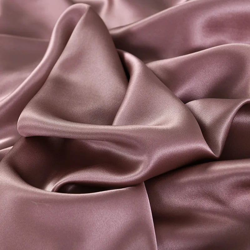 Close-up of purple satin fabric with folds