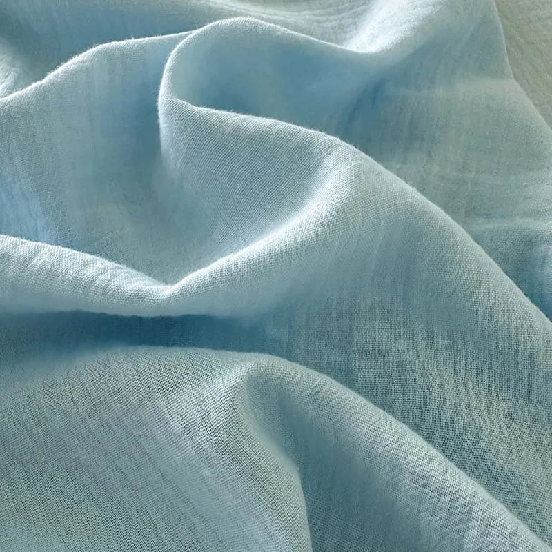 Close-up of light blue fabric with folds