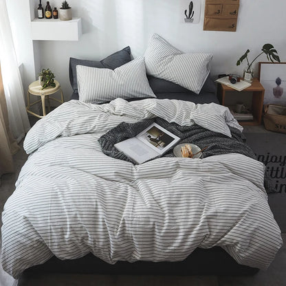 Striped bedding on a bed in a bedroom with decor elements.