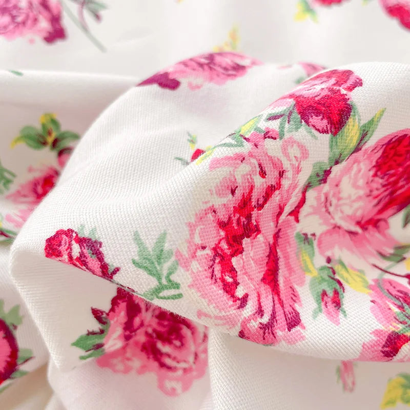 Close-up of floral fabric with pink flowers on a white background