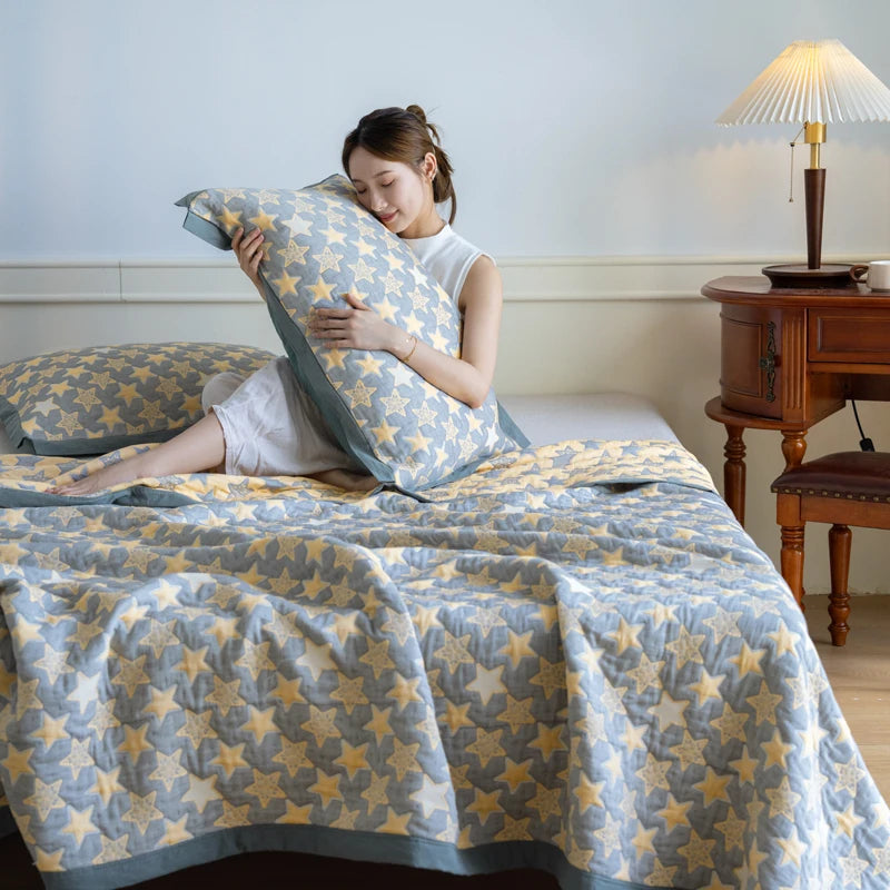 Woman holding a star-patterned pillow in a bedroom with a star-patterned blanket and pillows.