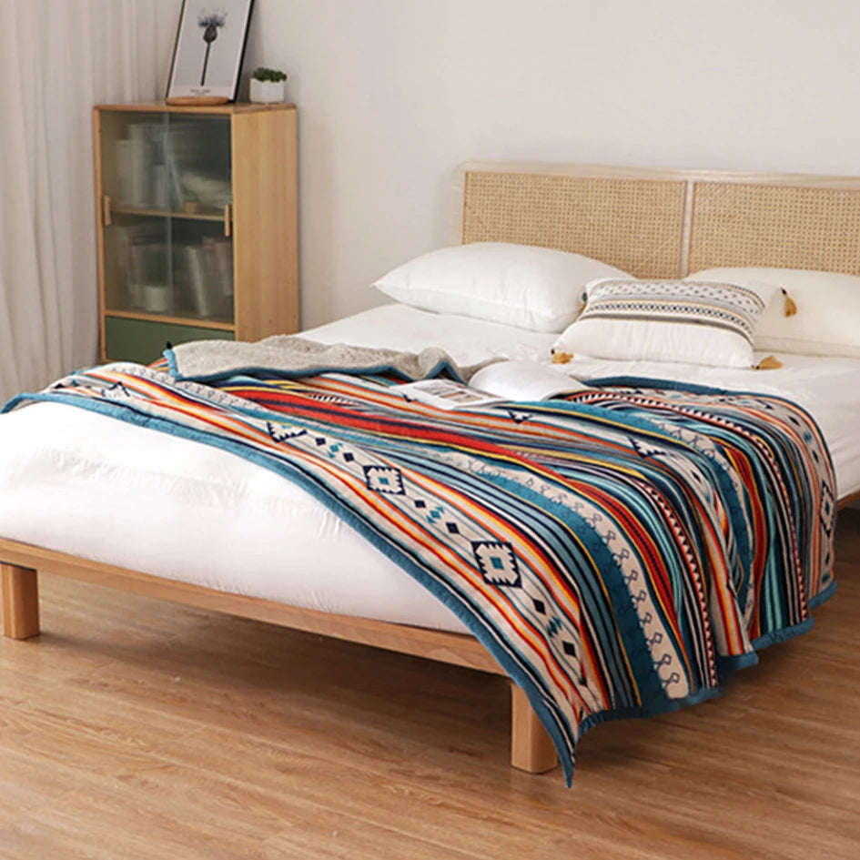 Bed with a colorful patterned blanket in a bedroom setting