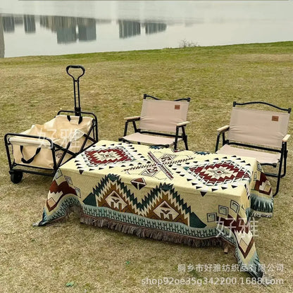 Outdoor setting with chairs, table, and trolley by a lake