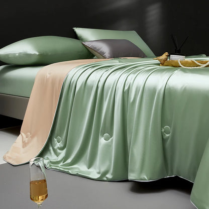 Bed with green satin blanket and pillows in a dark room