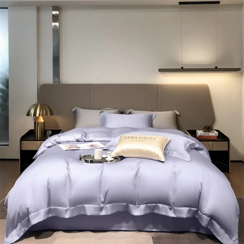 Modern bedroom with a bed featuring a purple comforter and decorative pillows.