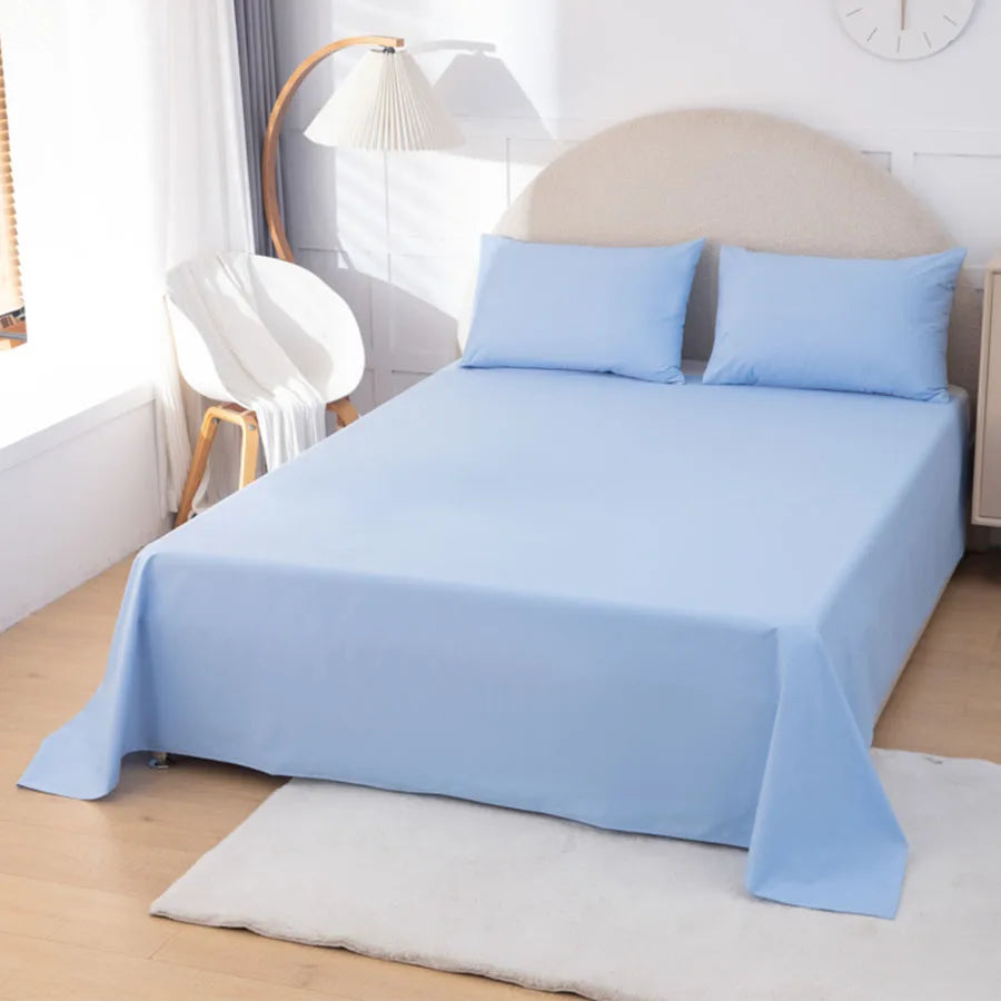 Blue bedspread and pillows on a bed in a bedroom setting