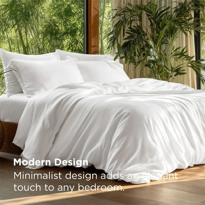 White bedding set on a bed with a minimalist design, surrounded by plants.