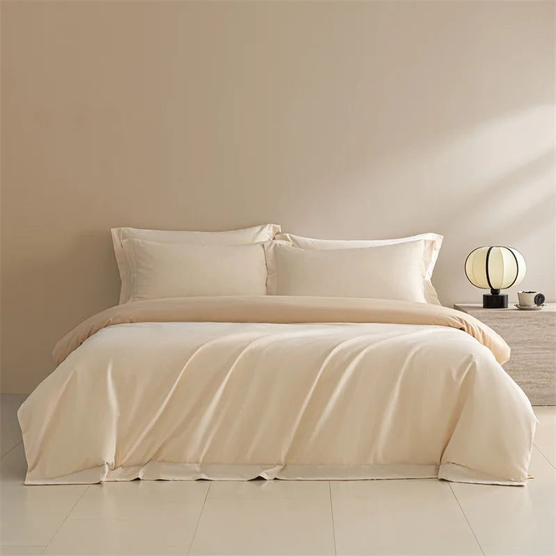 Beige bedding set on a bed in a minimalistic bedroom with a lamp and nightstand.