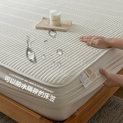 Bedding set with waterproof and urine-blocking feature on a bed, showing hands interacting with it.
