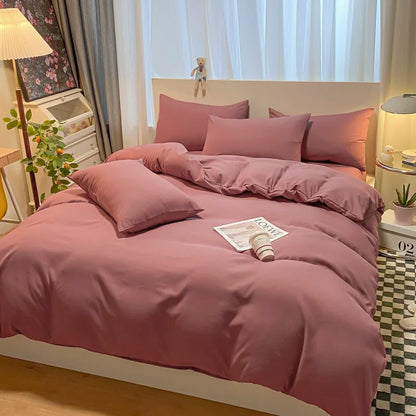 Bed with pink bedding in a bedroom setting with decor elements.