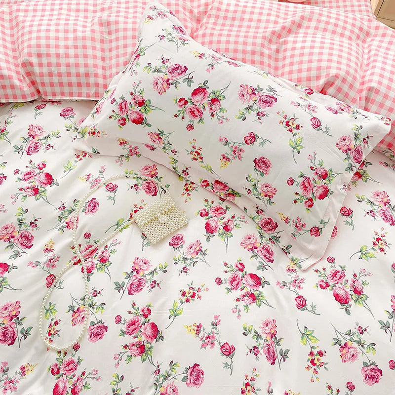 Floral bedding set with pink roses on a white background