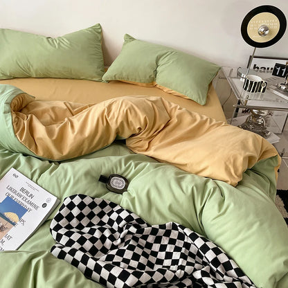 Bed with green and yellow bedding, checkered blanket, and nightstand with lamp.