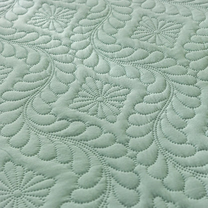 Close-up of textured green fabric with a pattern