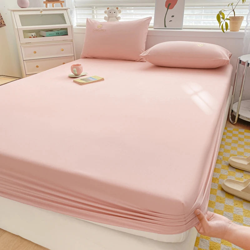Pink bed sheet set on a bed in a bedroom setting