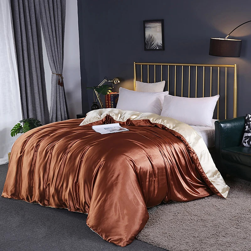 Bedroom with a bed featuring brown satin duvet and gold headboard.