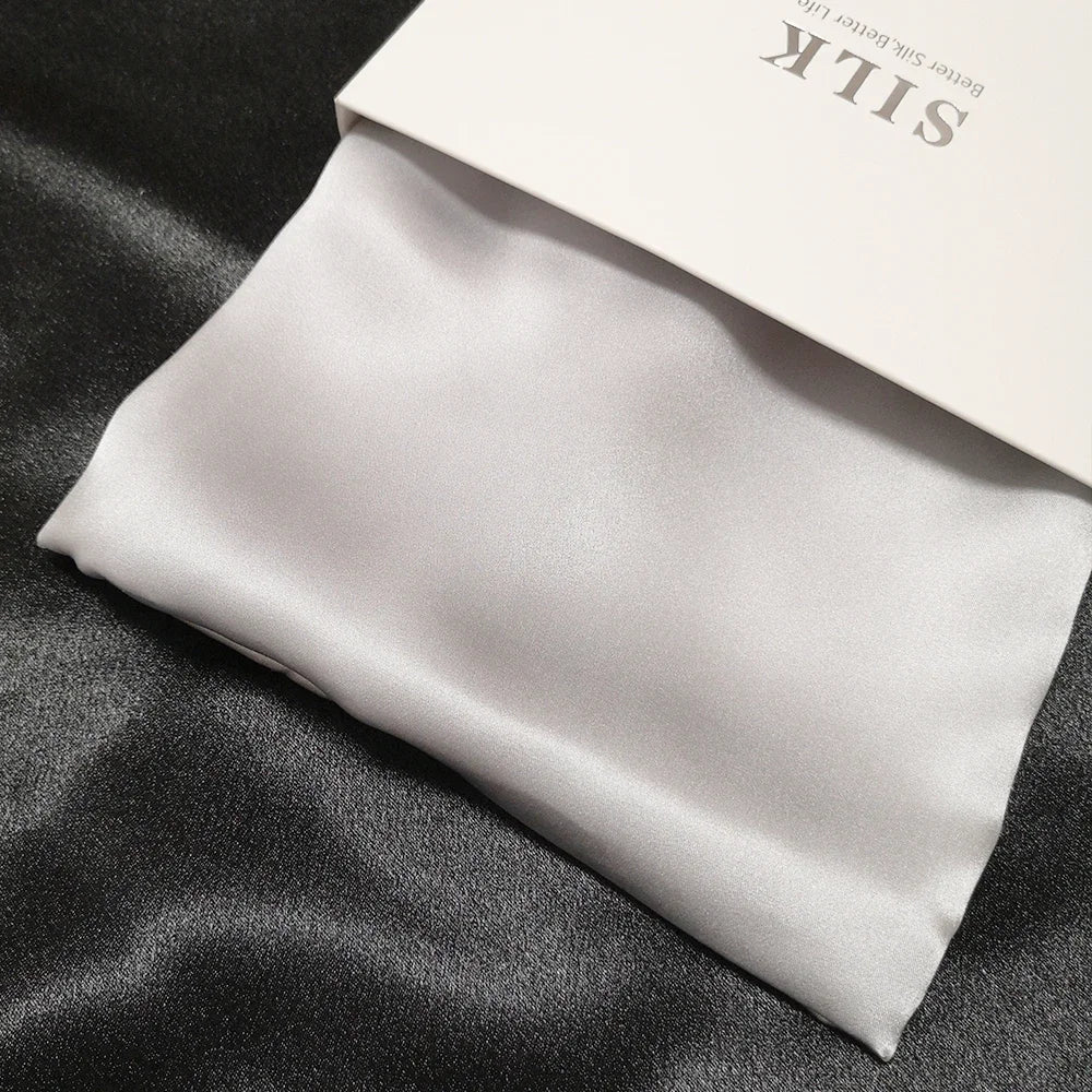 Silk fabric with a visible brand label on a dark surface