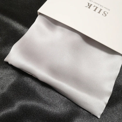 Silk fabric with a visible brand label on a dark surface
