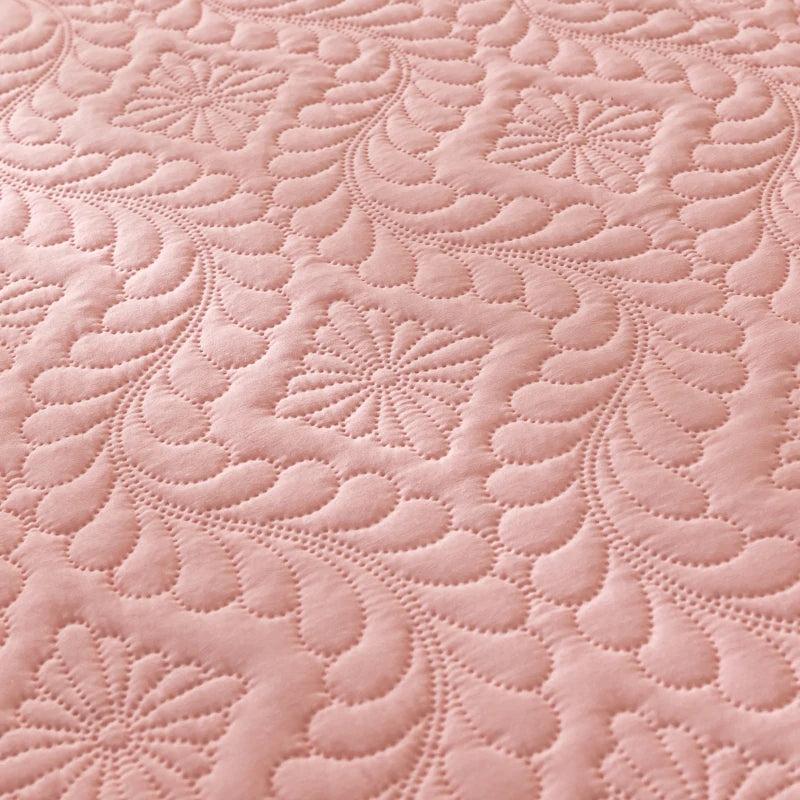 Close-up of pink quilted fabric with intricate patterns