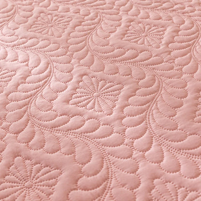 Close-up of pink quilted fabric with intricate patterns